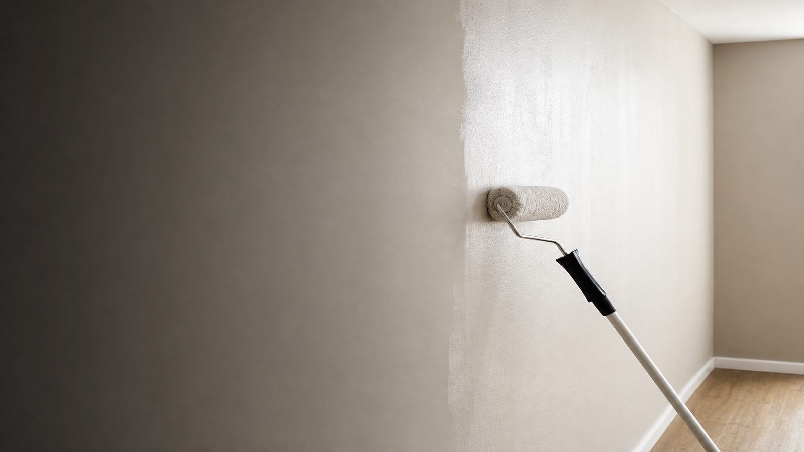 Painter cutting in a clean edge on a wall